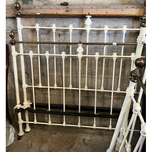 70 - A 19thC 4 ft 6 brass and iron bedstead on castors with side rails.