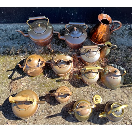 948 - Assorted copper and brassware to include eleven kettles and two jugs. (13)