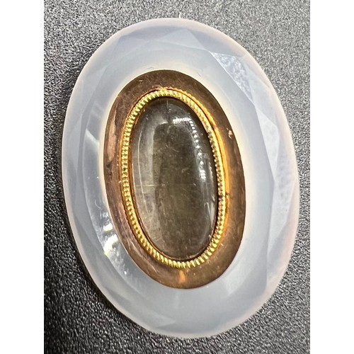 556 - A 19thC moonstone and yellow metal brooch inscribed to rear Godfrey Hirst 3rd February 1807. 2 x 2.5... 