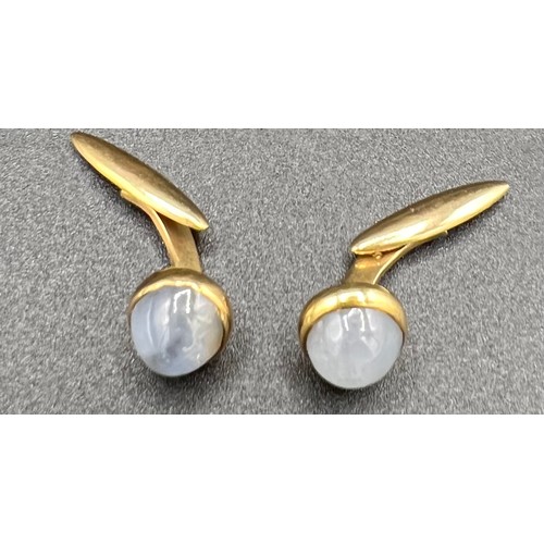 561 - A pair of 14ct gold cufflinks set with moonstone.