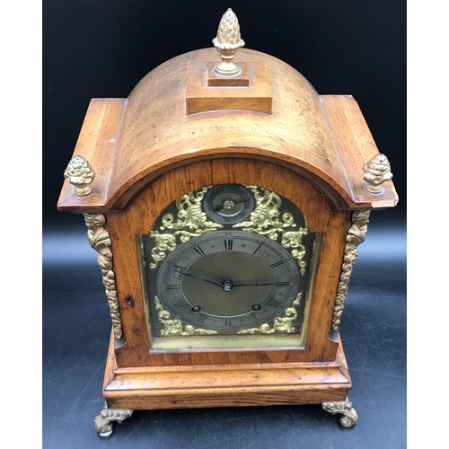 1021 - Walnut mantle clock 44 h x 27 w x 19cm d on four brass feet, brass face, 3 brass acorn decorations t... 