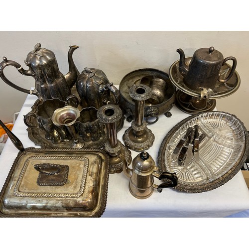 782 - A large quantity of silver plated items to include entrée dish, candlesticks, vases, tea service.