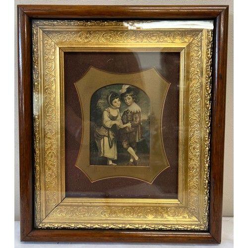 1102 - A 19thC print of two children in a decorative gilt and rosewood frame. 37 x 33cm.