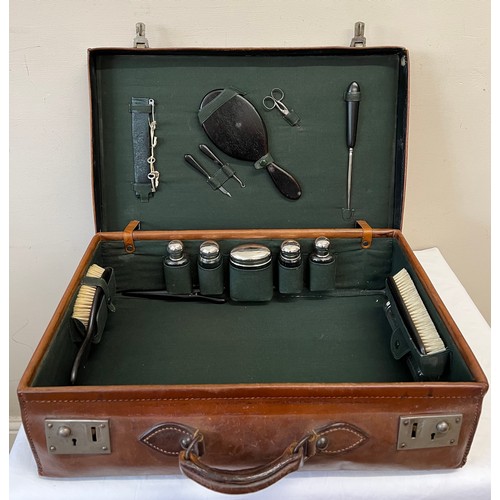 1259 - A gentleman's fitted leather suitcase to include ebony mirror, brushes, glove stretchers, bottles et... 