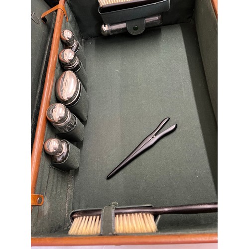 1259 - A gentleman's fitted leather suitcase to include ebony mirror, brushes, glove stretchers, bottles et... 