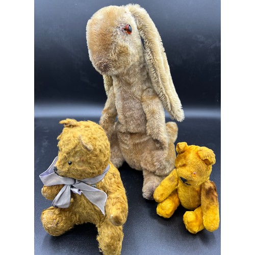 997 - An early 20thC straw filled rabbit together with 2 vintage teddies. Rabbit 24cm h.