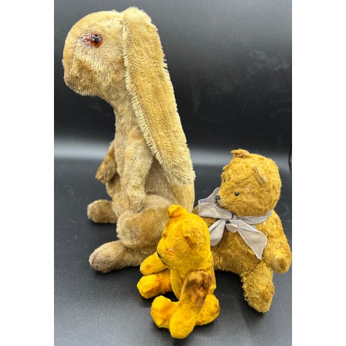 997 - An early 20thC straw filled rabbit together with 2 vintage teddies. Rabbit 24cm h.