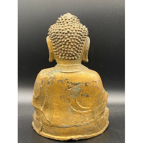 762 - An antique gilded bronze Shakyamuni Buddha believed to be pre 19thC seated in padmasana, his hands i... 