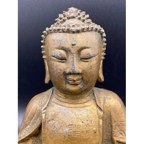 762 - An antique gilded bronze Shakyamuni Buddha believed to be pre 19thC seated in padmasana, his hands i... 