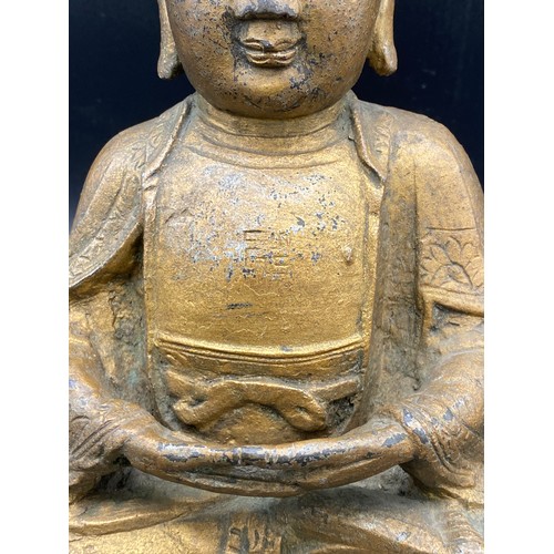 762 - An antique gilded bronze Shakyamuni Buddha believed to be pre 19thC seated in padmasana, his hands i... 