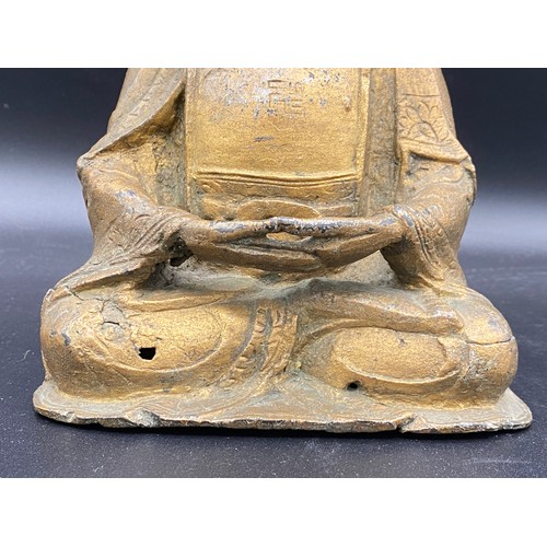 762 - An antique gilded bronze Shakyamuni Buddha believed to be pre 19thC seated in padmasana, his hands i... 