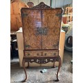 A burr walnut cocktail cabinet with decorative brass fittings. 70 w x 43 d x 159cm h on cabriole leg... 