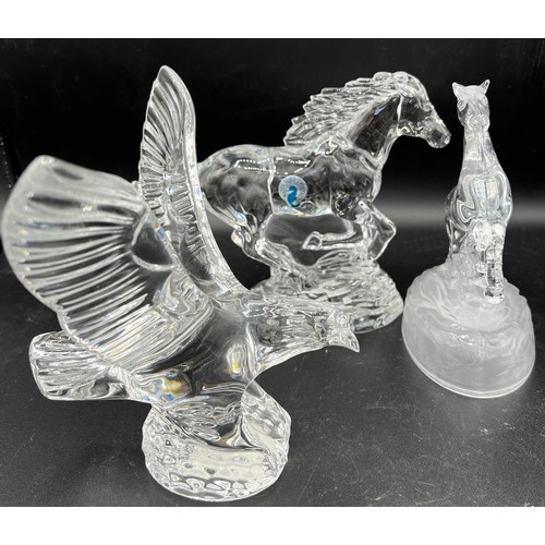 521 - A Waterford crystal clear glass model of a galloping horse with label, Waterford eagle and an unmark... 