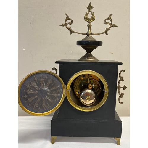 1019 - A 19thC French black and pink marble mantle clock on brass lion's paw feet. 39 x 22cm w.