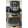 Two dark green leather Stressless reclining armchairs plus footstools, one Grandfather and one Grand... 