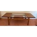 A mid century teak and glass coffee table 136 x 50cm.