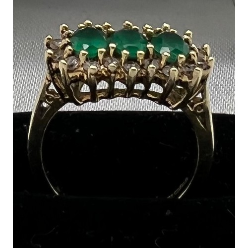 551 - An emerald and diamond ring, 3 emeralds surrounded by diamonds set in 9ct gold. Size M. 3.9gm.