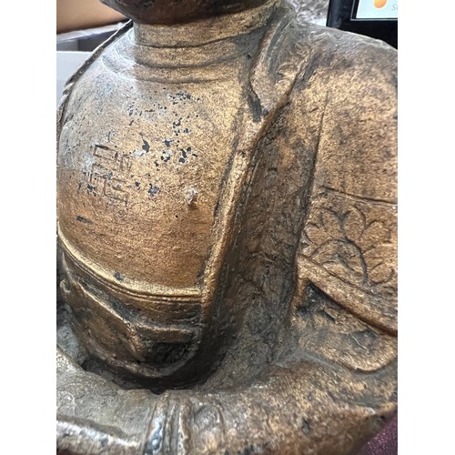 762 - An antique gilded bronze Shakyamuni Buddha believed to be pre 19thC seated in padmasana, his hands i... 