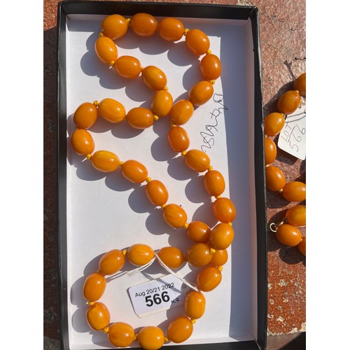 566 - Two string of butterscotch amber beads, approx length 80 & 52cm. 213.9gm.