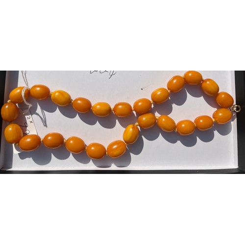 566 - Two string of butterscotch amber beads, approx length 80 & 52cm. 213.9gm.