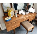 A G-Plan teak dressing table with triple mirror to top 150 w x 42 d x 122 h to top of mirror. 5 draw... 