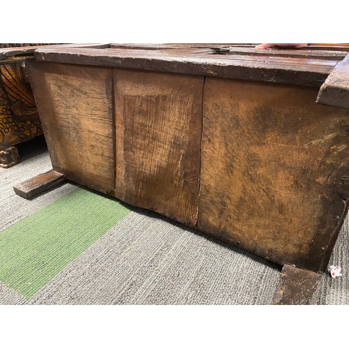 127 - A late 17thC/early 18thC small oak coffer with sunken two panel lid above carved frieze and carved p... 