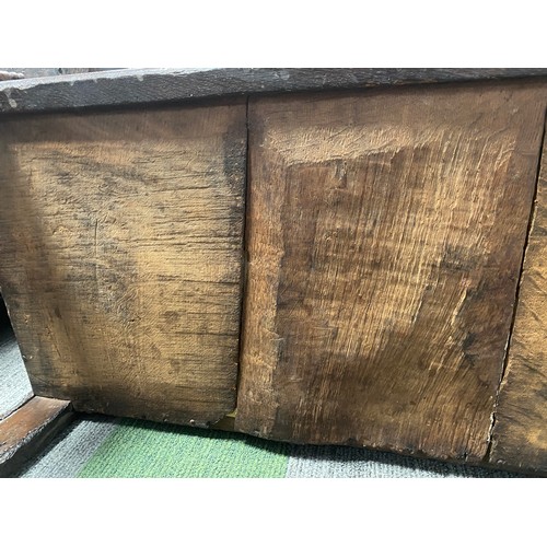 127 - A late 17thC/early 18thC small oak coffer with sunken two panel lid above carved frieze and carved p... 