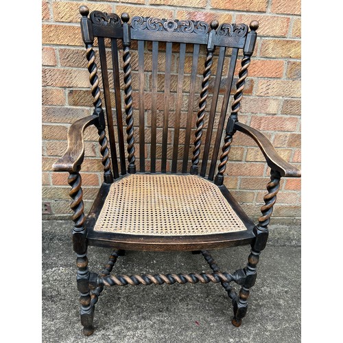 65 - A cane seated oak barley twist armchair.