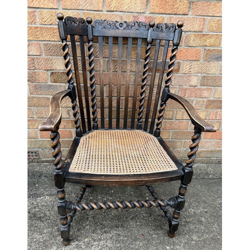 65 - A cane seated oak barley twist armchair.