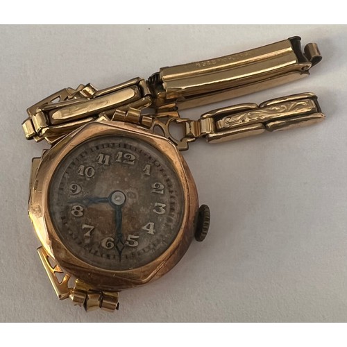 971 - A 9ct gold cased ladies wristwatch with a rolled gold strap. Total weight 13.6gm.