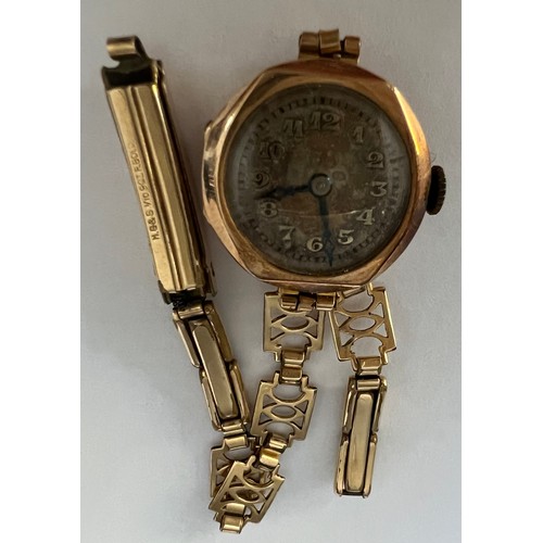 971 - A 9ct gold cased ladies wristwatch with a rolled gold strap. Total weight 13.6gm.