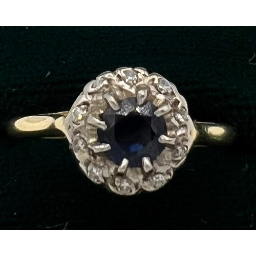 534 - An 18ct sapphire and diamond cluster ring. Size 0, weight 2.8gm.