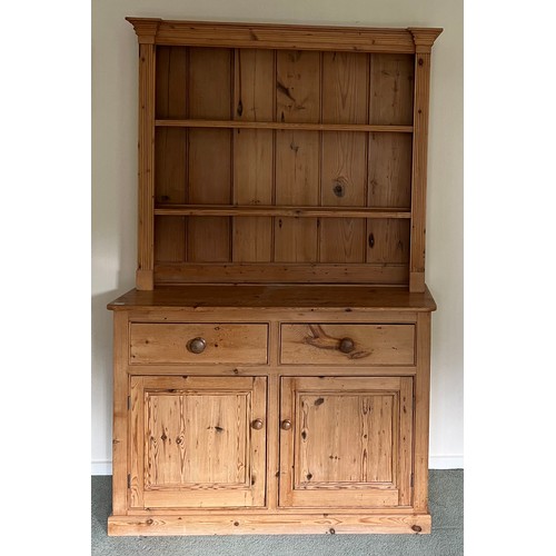 73 - Pine dresser with 2 drawers over 2 cupboards and rack to back. 125w x 43d x 198h.