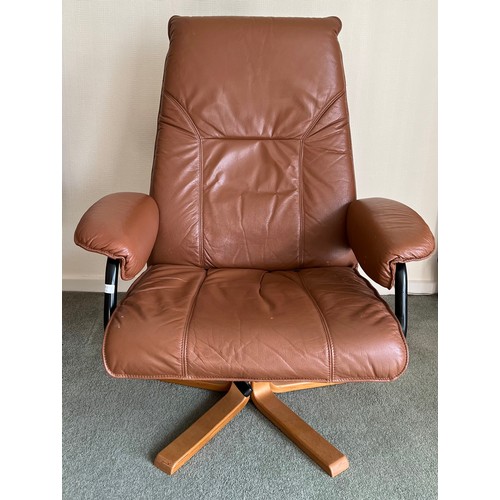 74 - A Unico swivel brown leather armchair with adjustable back angle.