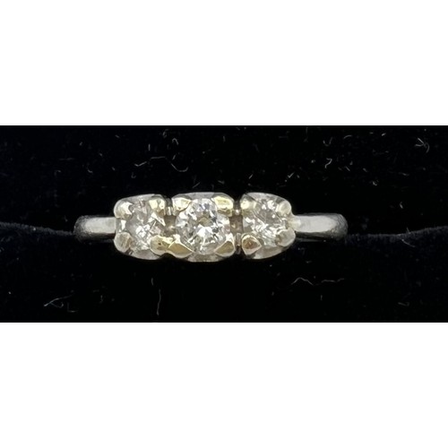 545 - A three stone diamond ring set in platinum. Size M, weight 4.7gm.