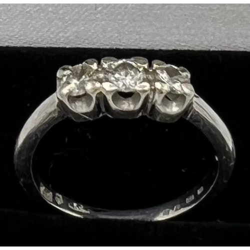 545 - A three stone diamond ring set in platinum. Size M, weight 4.7gm.