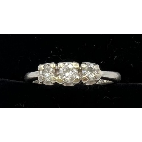 545 - A three stone diamond ring set in platinum. Size M, weight 4.7gm.