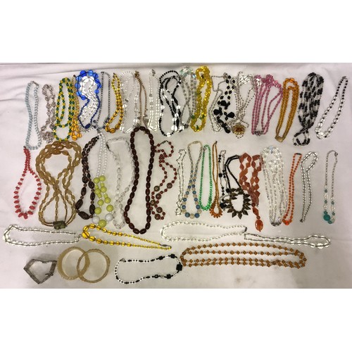 544 - A quantity of good quality vintage glass bead necklaces, bangles and bracelet.