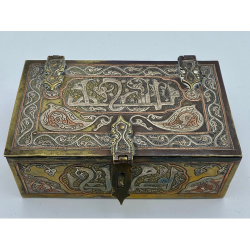 945 - A good quality Cairo Ware silver, copper and brass inlaid rectangular casket with script and foliate... 