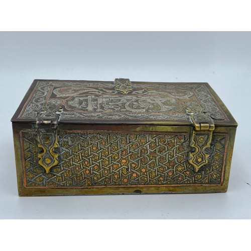 945 - A good quality Cairo Ware silver, copper and brass inlaid rectangular casket with script and foliate... 