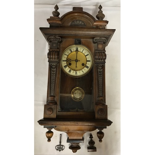 1187 - A wall clock with R A marked on pendulum with key. Approx. 60 h x 16 d x 30cm w.