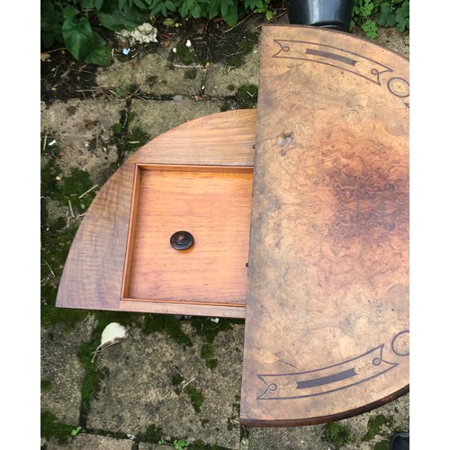 71 - A Victorian walnut demilune card table, hinged top enclosing a baize lined playing surface, turned c... 