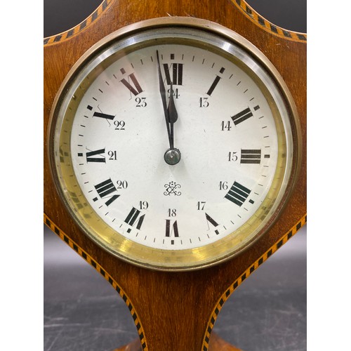 1181 - An Edwardian mahogany inlaid mantel clock with brass feet, finial and key.