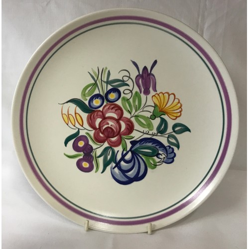 297 - Eleven pieces of Poole pottery. Largest plate measuring 25.5cm d.