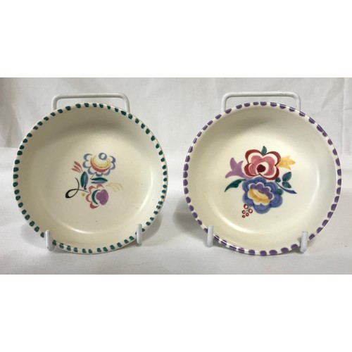 297 - Eleven pieces of Poole pottery. Largest plate measuring 25.5cm d.