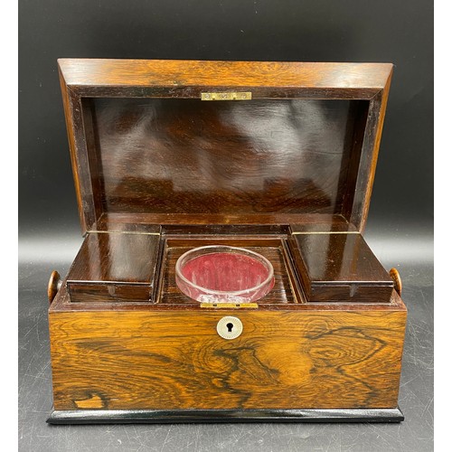 1003 - A 19thC rosewood tea caddy with two lined compartments and a central glass mixing bowl, mother of pe... 