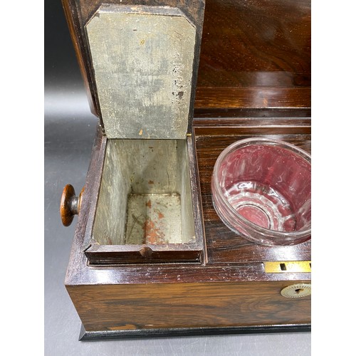 1003 - A 19thC rosewood tea caddy with two lined compartments and a central glass mixing bowl, mother of pe... 