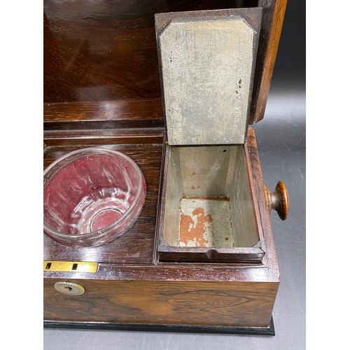 1003 - A 19thC rosewood tea caddy with two lined compartments and a central glass mixing bowl, mother of pe... 