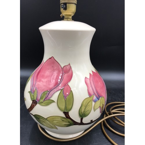 308 - A Moorcroft pottery table lamp decorated with Magnolia design on a cream background, 32 cm h to top ... 