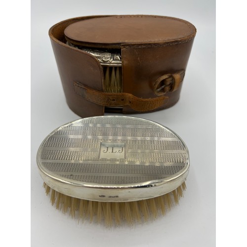 751 - A pair of gentleman's silver backed hairbrushes in original  leather case Chester 1931 together with... 